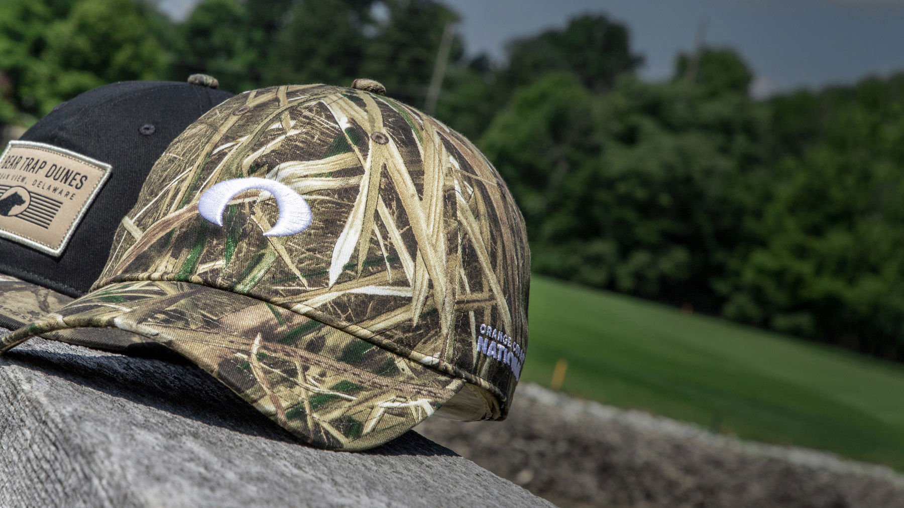 Camo hat sitting on stone wall
