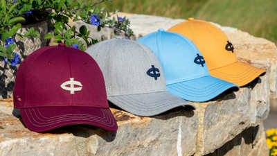 Golf hats sitting on stone wall