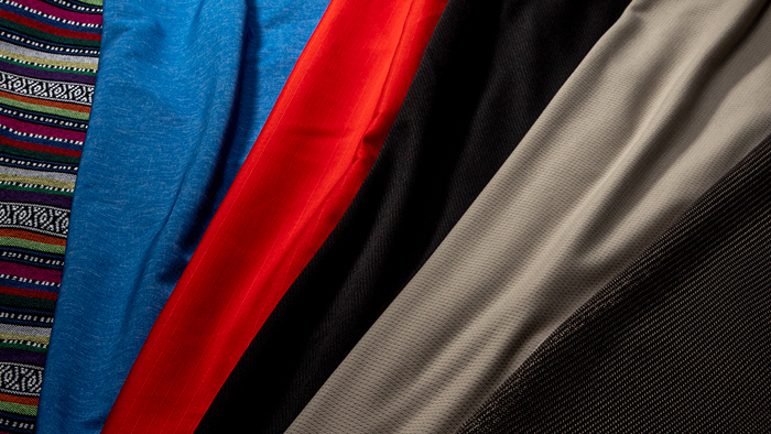 Pukka Logo on a wall surrounded by hanging hats