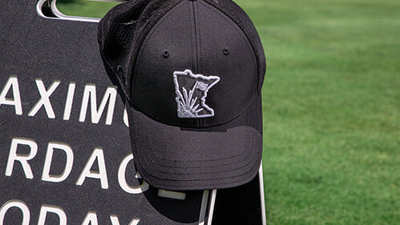 Golf Ultra-Fit hat sitting on a rock