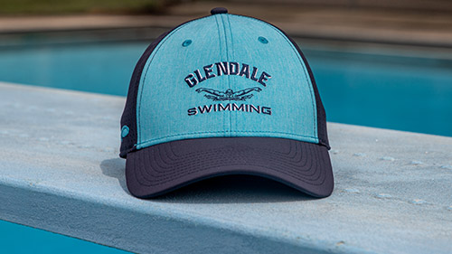 Team Sports Swim & Dive hat on a diving board