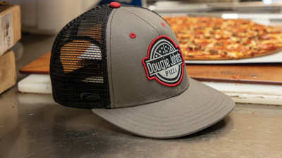Hat sitting with pizza on work surface